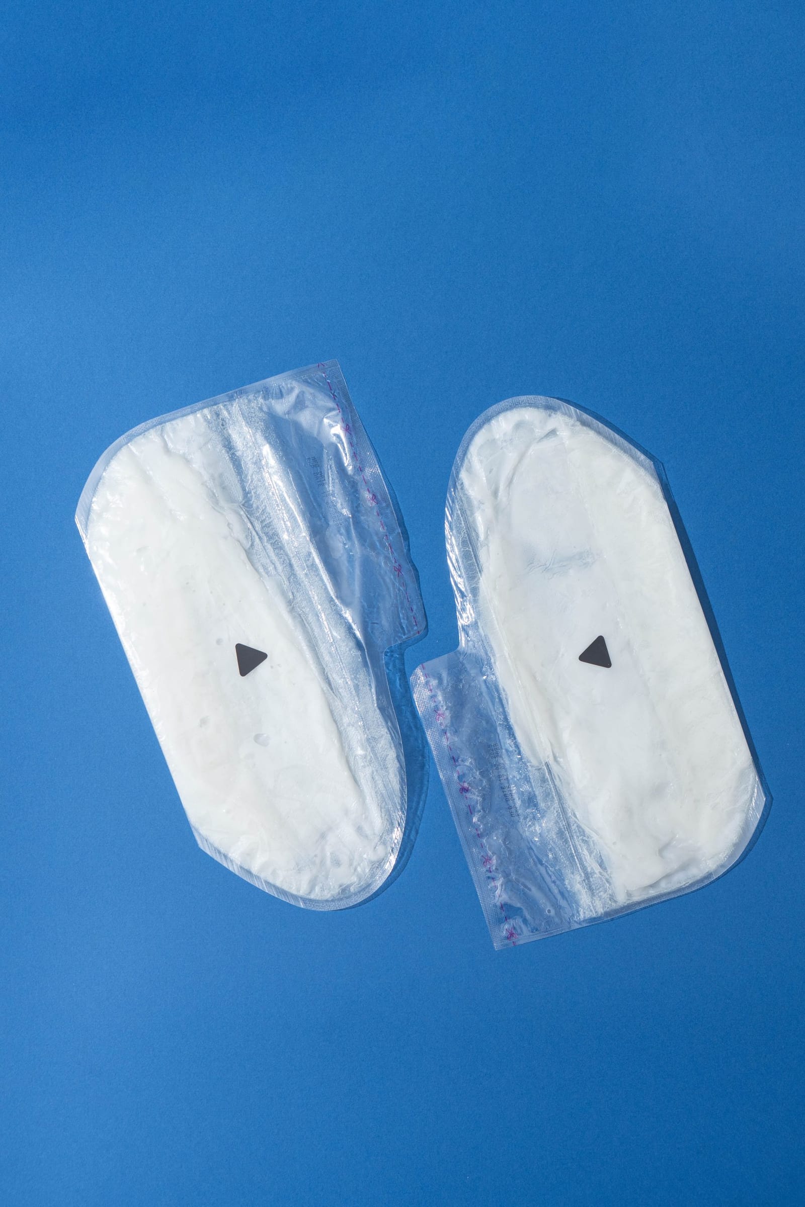 A pair of bootie-shaped paraffin beauty wax foot masks in their sealed packs