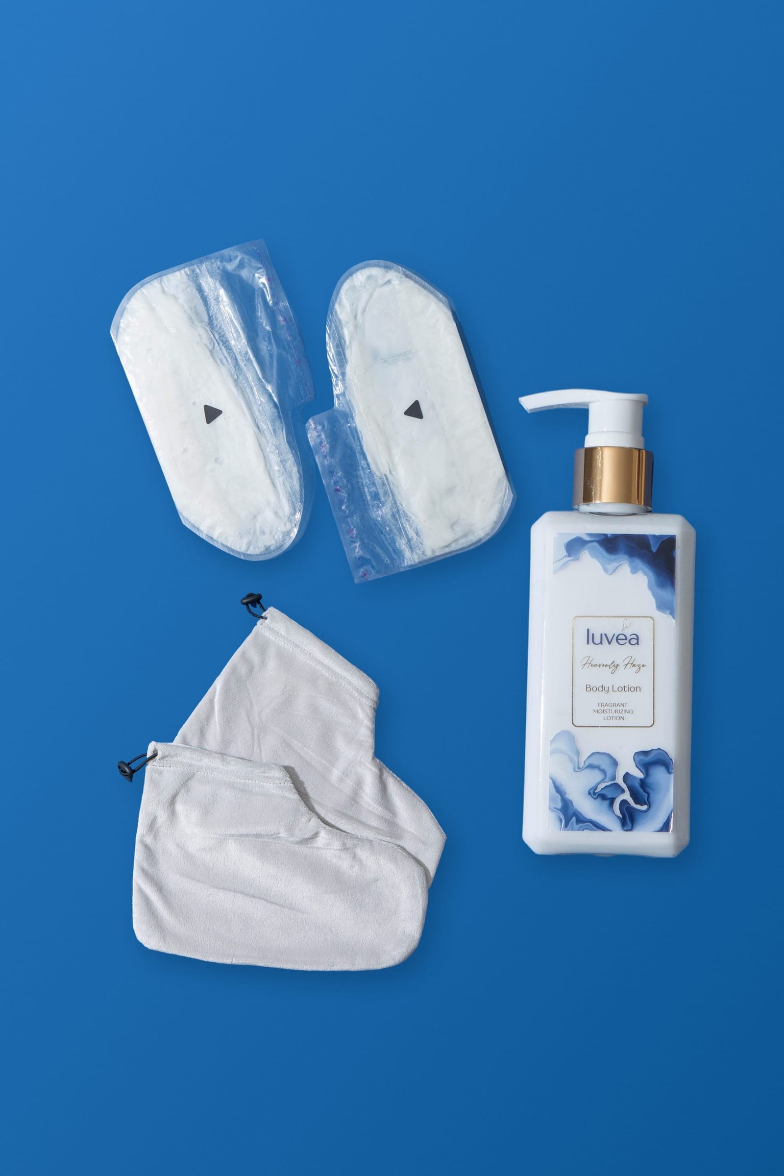 The Foot Ritual with cream: paraffin beauty wax foot masks, terry cloth covers and a bottle of Heavenly Haze body lotion