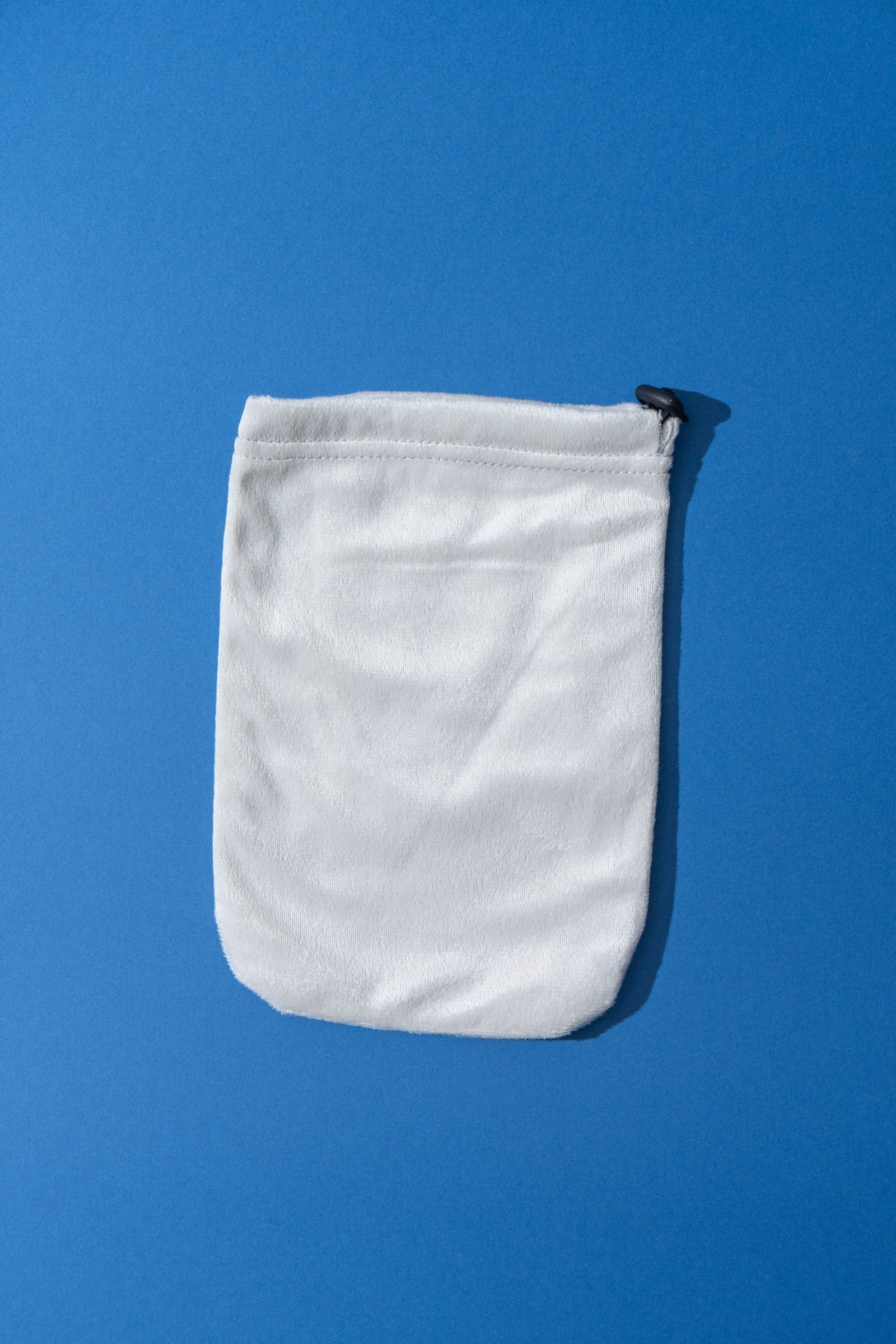 A single reusable terry cloth hand cover with its drawstring closure